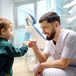 Dentist giving fist bump to little boy