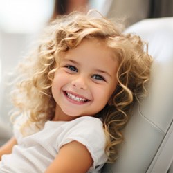 Child smiling while in the treatment chair