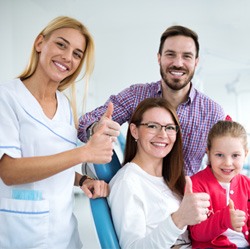 Family smiling at the dentist’s office